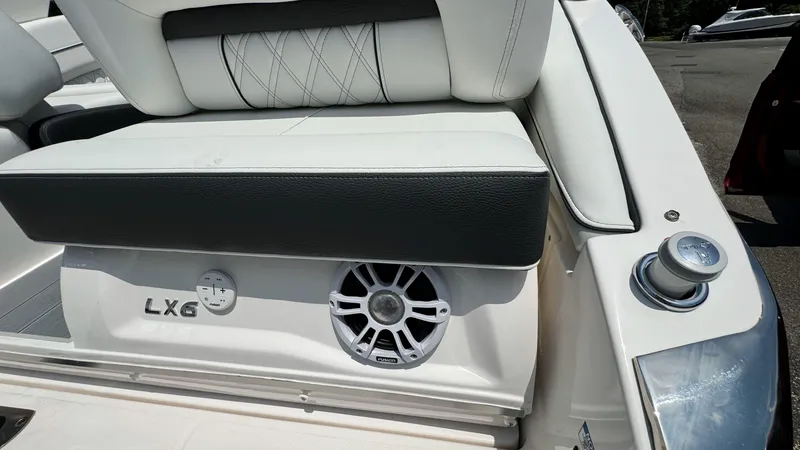 Slide: The Image of 2025 Regal LX6 boat interior with speaker and seating. - 8