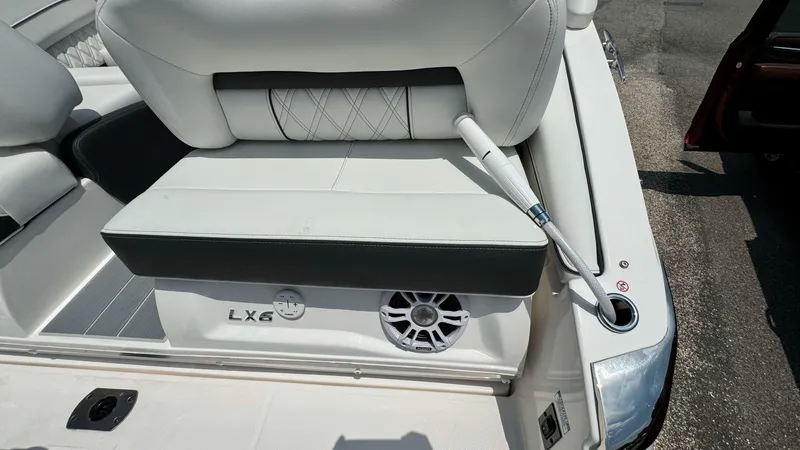 Slide: The Image of 2025 Regal LX6 boat interior with white seating and speaker. - 9