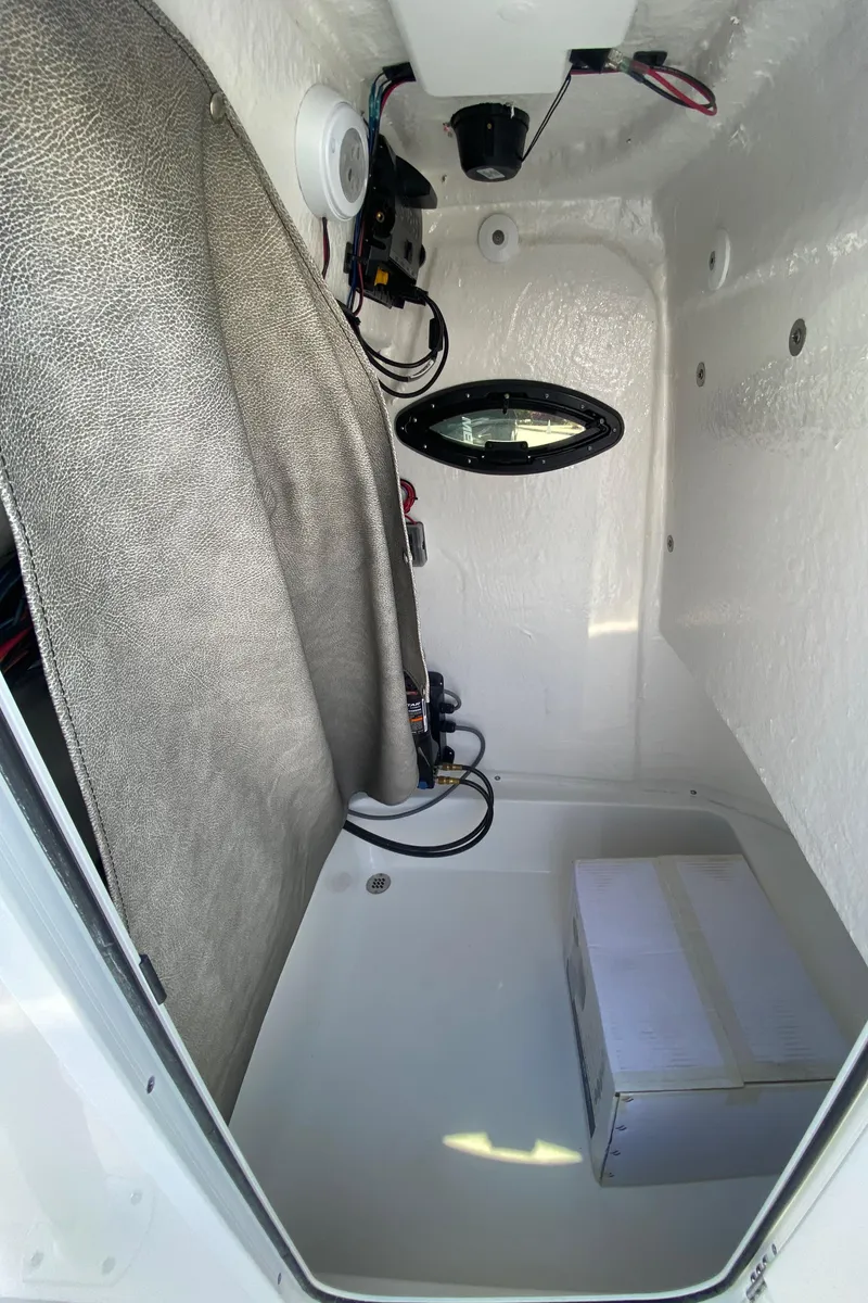 Slide: The Image of 2024 Sea Pro 222 Center Console interior storage compartment with wiring and equipment. - 13