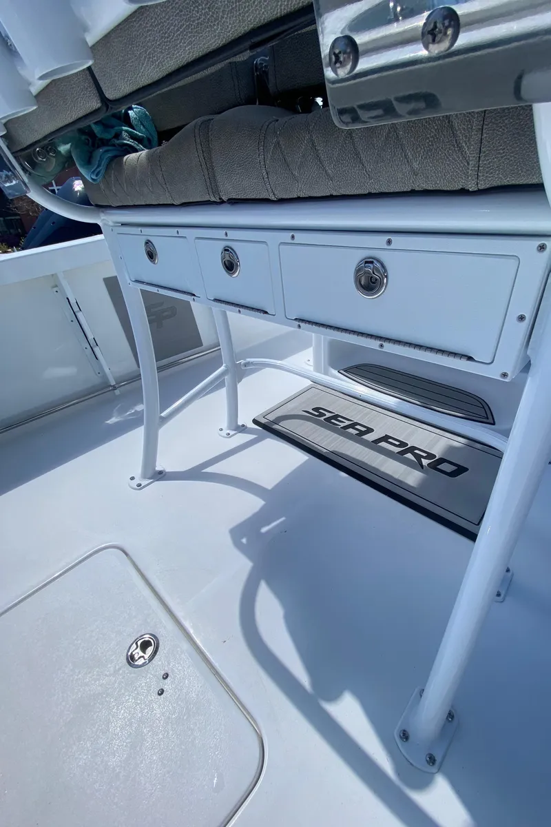 Slide: The Image of 2024 Sea Pro 222 Center Console boat interior with storage compartments and seating. - 7