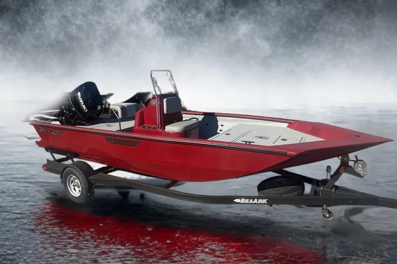 The Image of 2024 SeaArk 872 RX boat in red, parked on a trailer in a lot. - 0