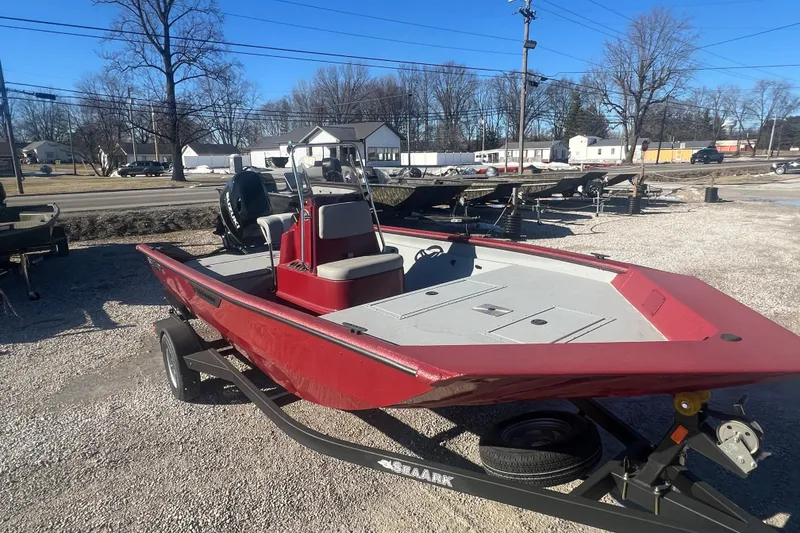 Slide: The Image of 2024 SeaArk 872 RX boat with Suzuki motor in a marina setting. - 2