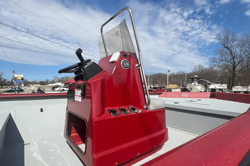 Slide: The Image of 2024 SeaArk 872 RX boat with red console under a clear blue sky. - 5
