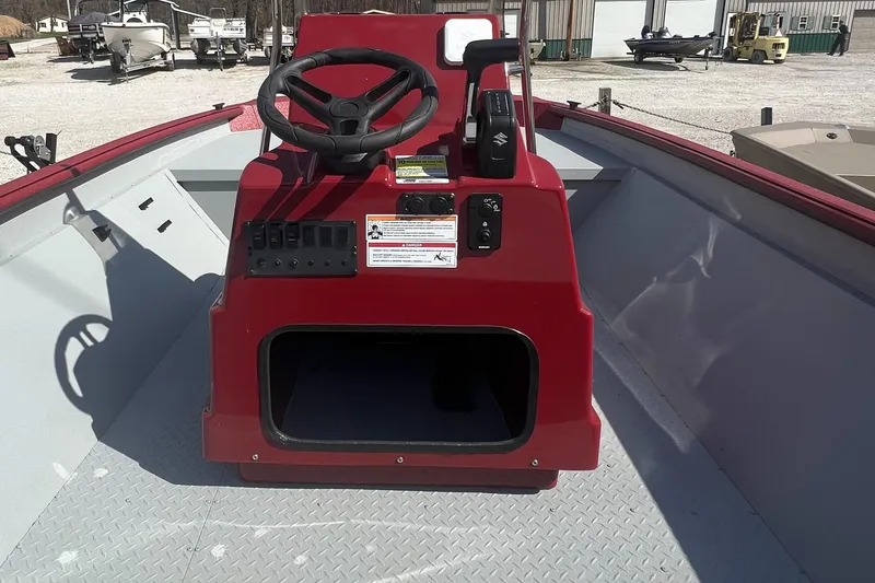 Slide: The Image of 2024 SeaArk 872 RX boat interior with red console and steering wheel. - 6