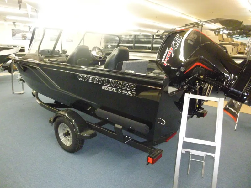 Slide: The Image of 2024 Crestliner 1750 Hawk WT w/ Jumpseat, black, on trailer, indoor showroom. - 2