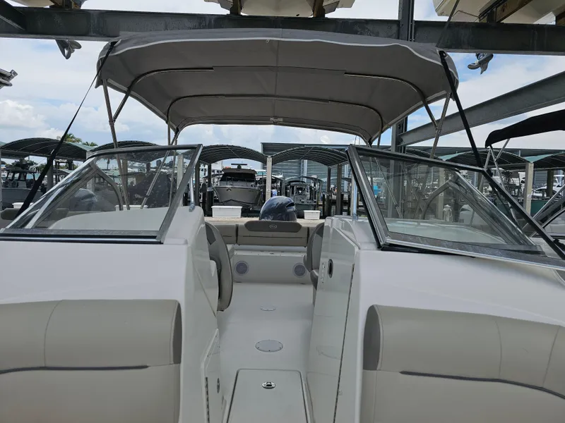 Slide: The Image of 2021 Key West 239 DFS boat with canopy, docked in a marina. - 10