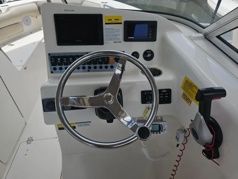 Slide: The Image of 2021 Key West 239 DFS boat dashboard with steering wheel and control panel. - 13