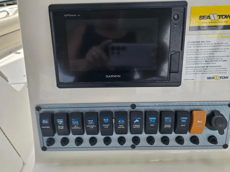 Slide: The Image of Control panel of a 2021 Key West 239 DFS boat with Garmin GPS and various switches. - 15