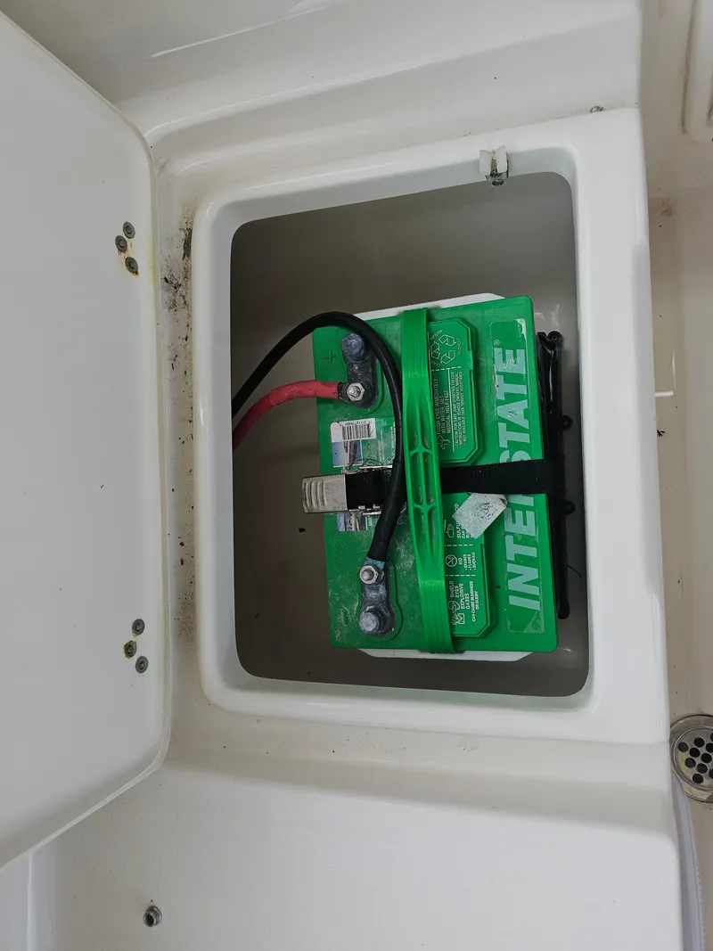 Slide: The Image of Battery compartment of a 2021 Key West 239 DFS boat with Interstate battery. - 19