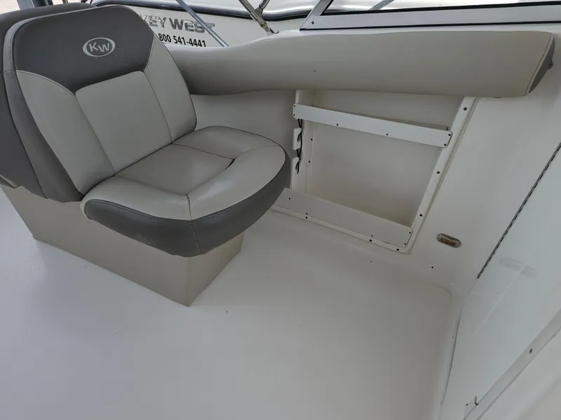 Slide: The Image of 2021 Key West 239 DFS boat interior with cushioned seat and clean white deck. - 26