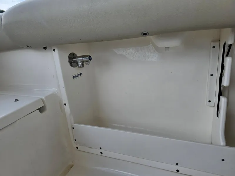 Slide: The Image of 2021 Key West 239 DFS boat interior showing raw water outlet. - 28