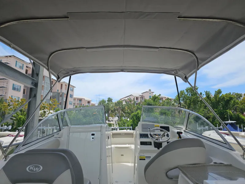 Slide: The Image of Interior view of 2021 Key West 239 DFS boat with canopy and steering console. - 34