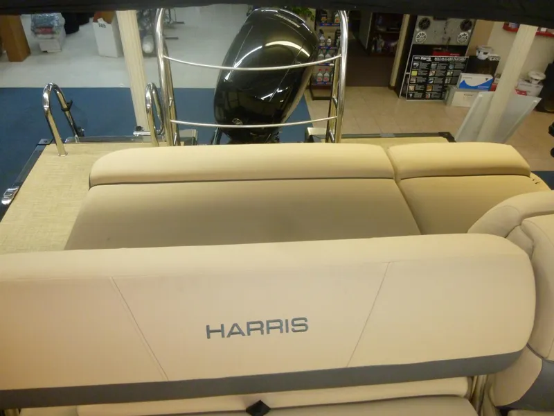 Slide: The Image of 2023 Harris FloteBote Cruiser 210 interior with beige seating and rear view. - 3