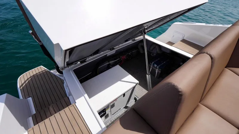 Slide: The Image of 2024 Oryx 379 boat with open engine compartment and brown seating. - 12