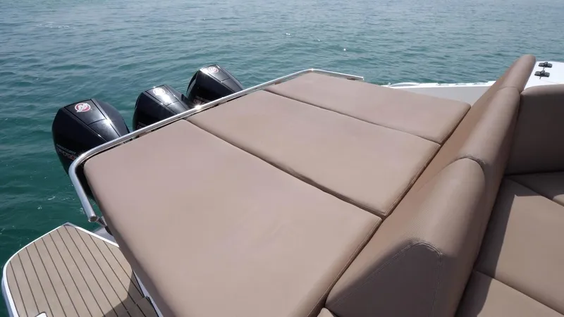 Slide: The Image of 2024 Oryx 379 boat with triple outboard engines and sunbed. - 9