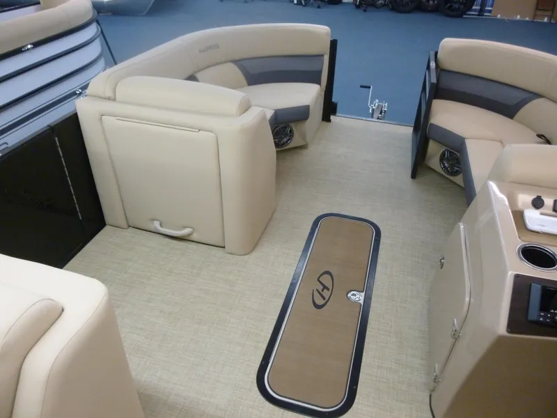 Slide: The Image of 2024 Harris Cruiser 230 Tritoon interior with beige seating and carpet. - 4