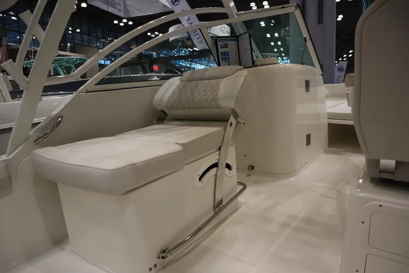Slide: The Image of 2024 World Cat 230DC boat interior with white seating and modern design. - 11