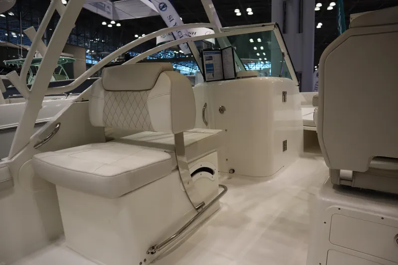 Slide: The Image of 2024 World Cat 230DC boat interior with white seating and modern design. - 12