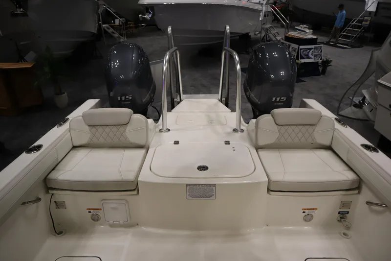 Slide: The Image of 2024 World Cat 230DC boat interior with dual engines and cushioned seating. - 14