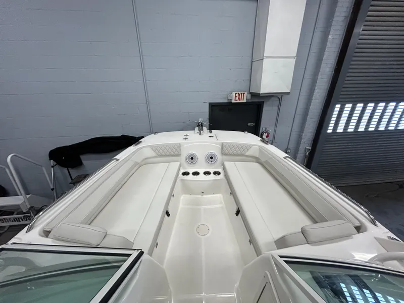 Slide: The Image of 2024 World Cat 230DC boat interior with white seating and speakers. - 3