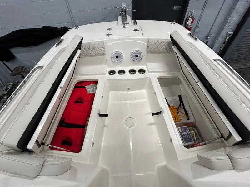Slide: The Image of 2024 World Cat 230DC boat interior with storage compartments and safety equipment. - 4