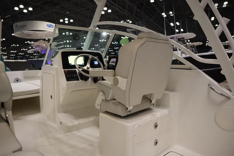 Slide: The Image of 2024 World Cat 230DC boat interior with modern helm and seating. - 6