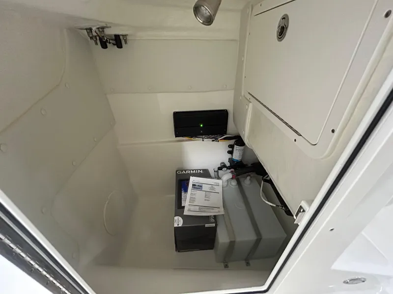 Slide: The Image of Interior storage compartment of 2024 World Cat 230DC boat with Garmin equipment. - 9