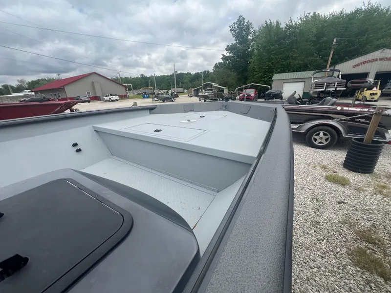 Slide: The Image of 2024 SeaArk 872 RX boat on display at a dealership lot. - 2
