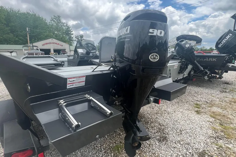 Slide: The Image of 2024 SeaArk 872 RX boat with Suzuki 90 outboard motor on gravel lot. - 4