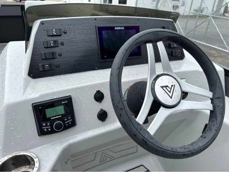 Slide: The Image of 2023 Viaggio Lago L25C boat dashboard with steering wheel, control panel, and Simrad display. - 10