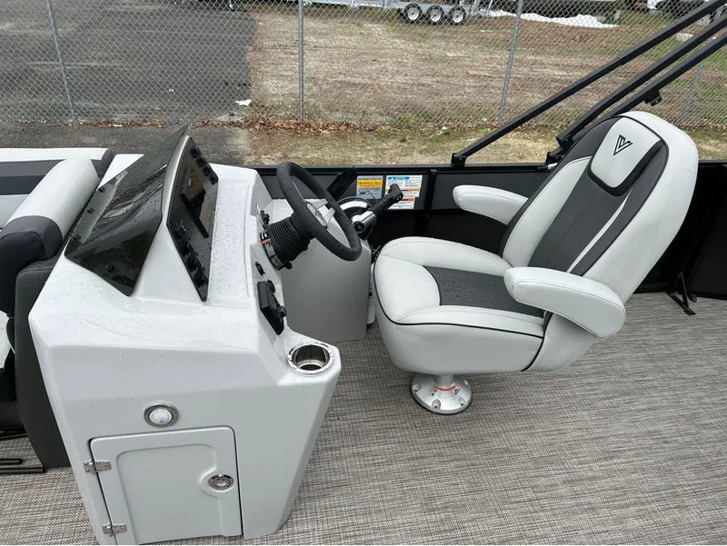 Slide: The Image of 2023 Viaggio Lago L25C boat cockpit with steering wheel and captain's chair. - 16