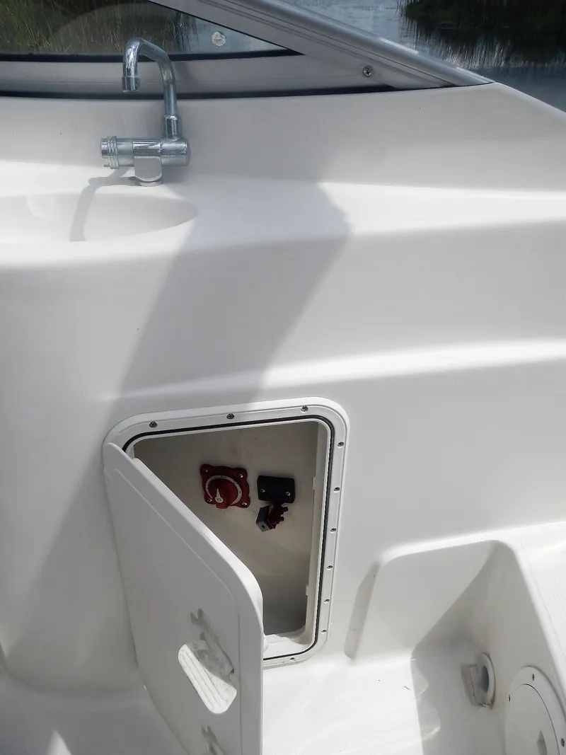 Slide: The Image of 2016 SouthWind 212 SD boat with open storage compartment and faucet. - 11