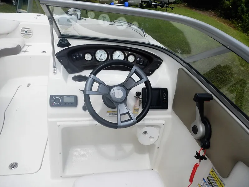 Slide: The Image of 2016 SouthWind 212 SD boat dashboard with steering wheel and control panel. - 12