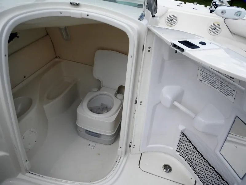 Slide: The Image of 2016 SouthWind 212 SD boat interior with a compact marine toilet. - 13