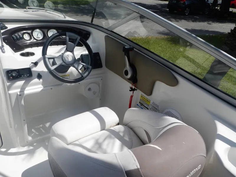 Slide: The Image of 2016 SouthWind 212 SD boat cockpit with steering wheel and captain's chair. - 17