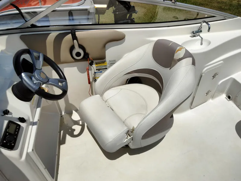 Slide: The Image of 2016 SouthWind 212 SD boat cockpit with steering wheel and captain's chair. - 18