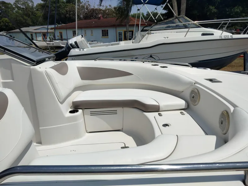 Slide: The Image of 2016 SouthWind 212 SD boat interior with white seating and speakers. - 23