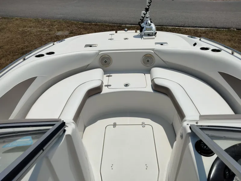 Slide: The Image of 2016 SouthWind 212 SD boat interior with white seating and storage compartments. - 25