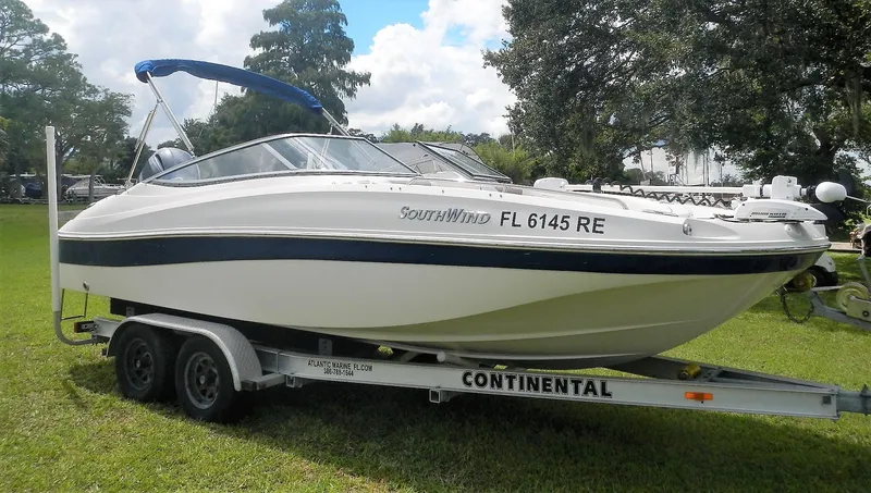 Slide: The Image of 2016 SouthWind 212 SD boat on a Continental trailer, parked on grass. - 8