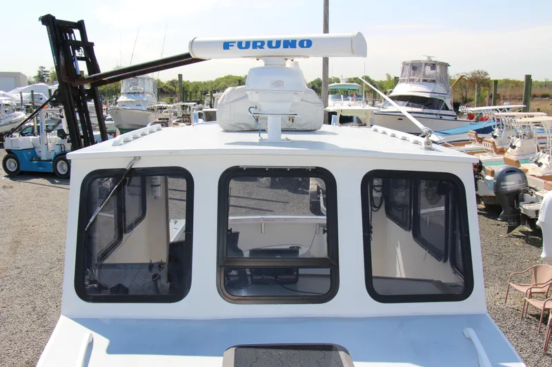 Slide: The Image of 2009 Custom Alley Boats 28 Downeast with Furuno radar at marina. - 11