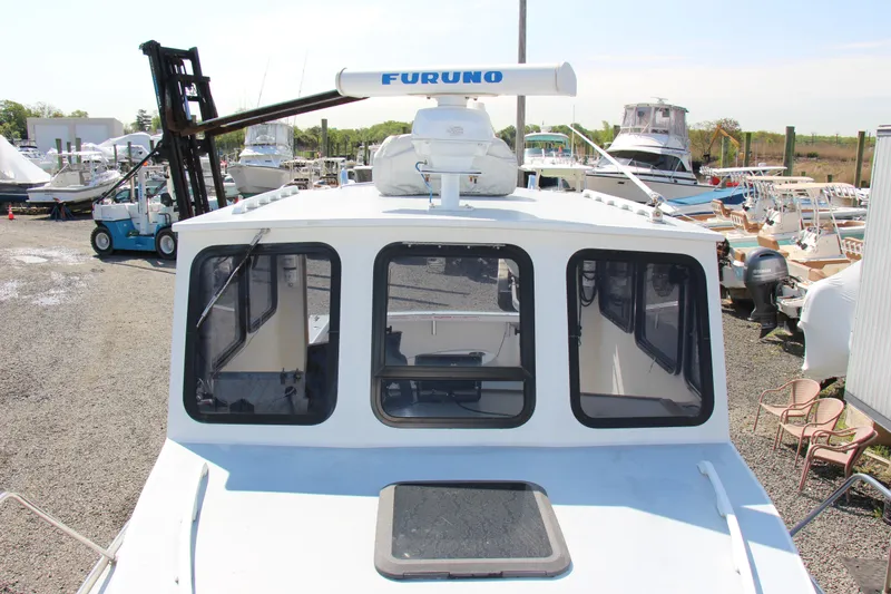 Slide: The Image of 2009 Custom Alley Boats 28 Downeast, docked, front view with Furuno radar. - 12
