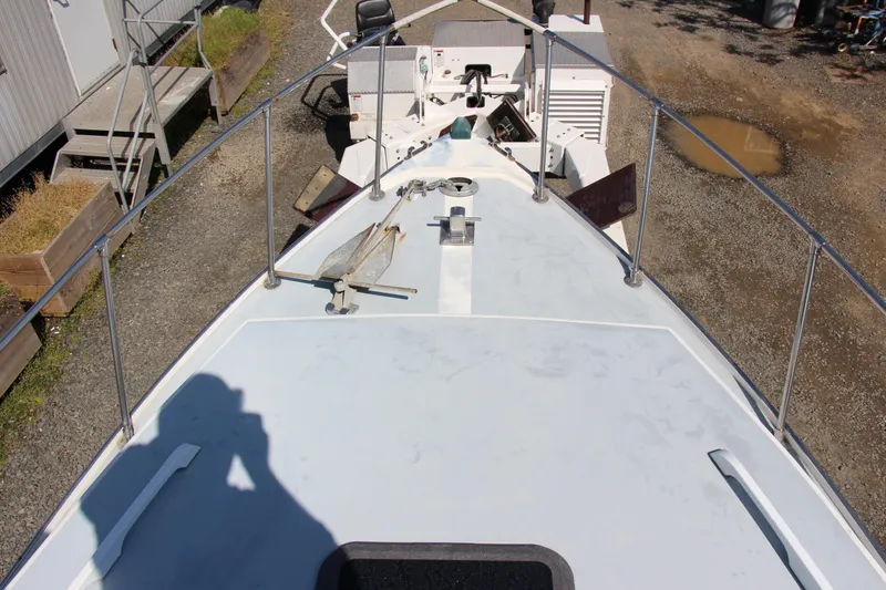 Slide: The Image of 2009 Custom Alley Boats 28 Downeast deck view with anchor and railings. - 13