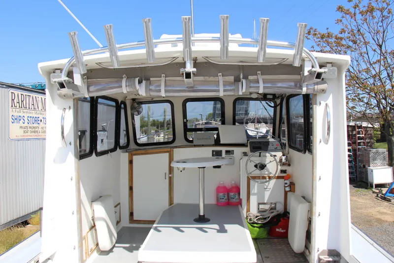 Slide: The Image of 2009 Custom Alley Boats 28 Downeast, spacious cockpit with fishing rod holders and navigation equipment. - 14