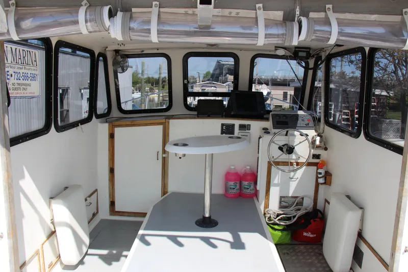 Slide: The Image of Interior of 2009 Custom Alley Boats 28 Downeast with steering wheel and navigation equipment. - 15