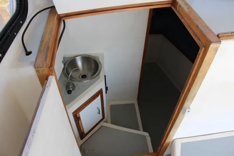 Slide: The Image of Interior of 2009 Custom Alley Boats 28 Downeast with sink and storage. - 20