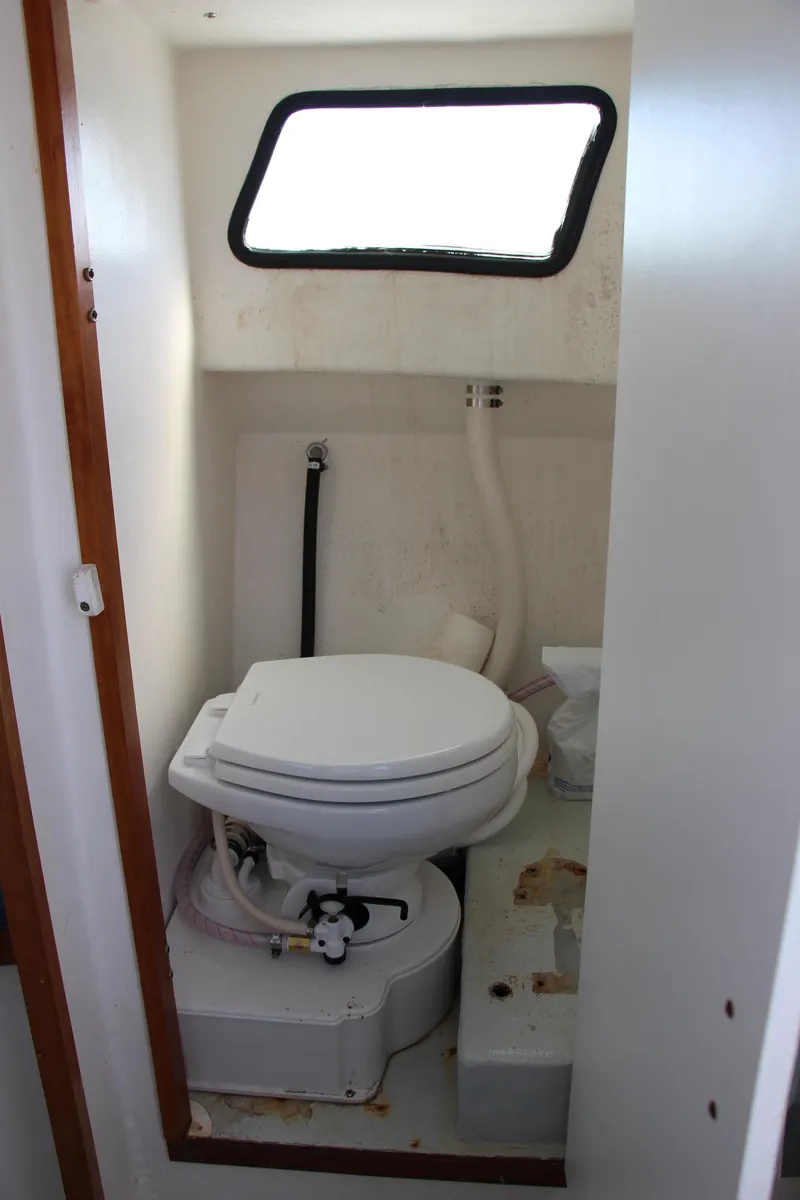Slide: The Image of 2009 Custom Alley Boats 28 Downeast marine toilet with window. - 22
