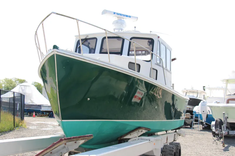 Slide: The Image of 2009 Custom Alley Boats 28 Downeast on trailer in boatyard. - 9