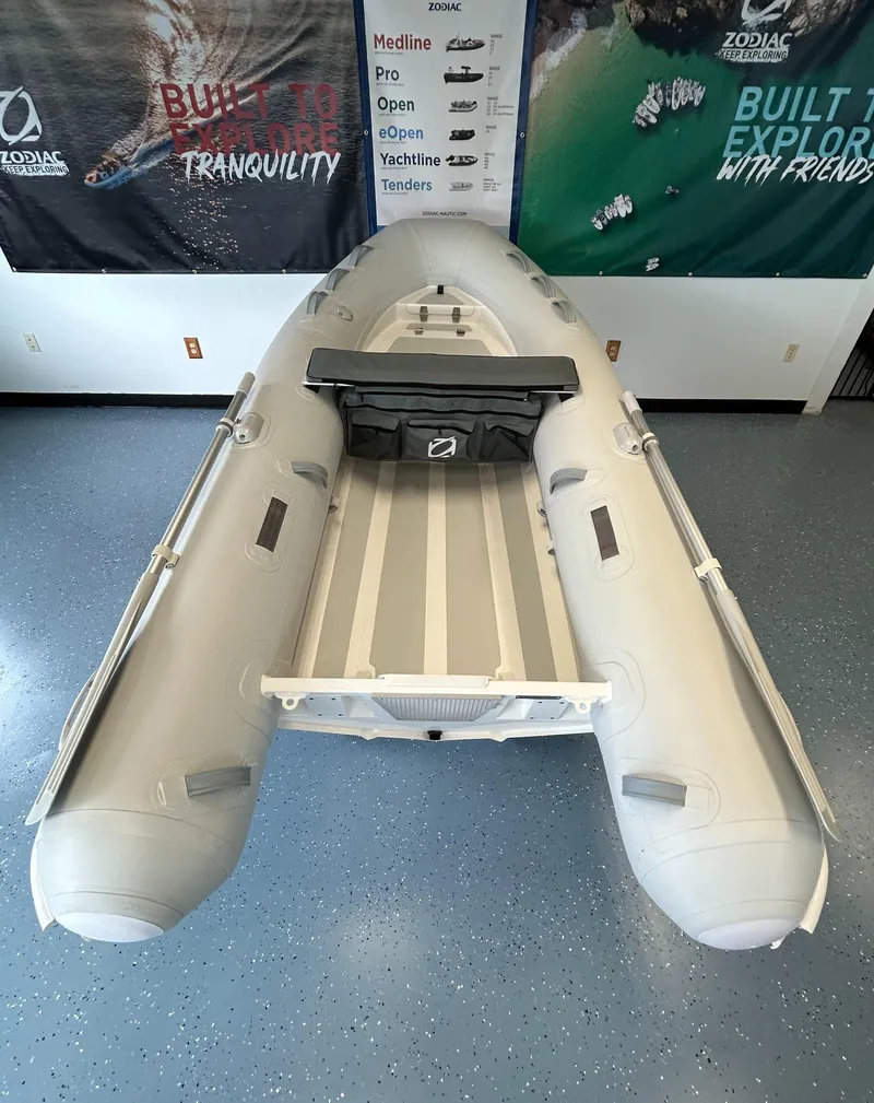 Slide: The Image of 2024 Zodiac Nomad RIB ALU 3.3 PVC inflatable boat in showroom. - 3