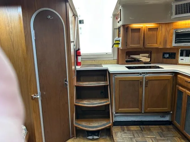 Slide: The Image of 1996 Luhrs 38 Open boat interior with wooden cabinetry and stairs. - 11