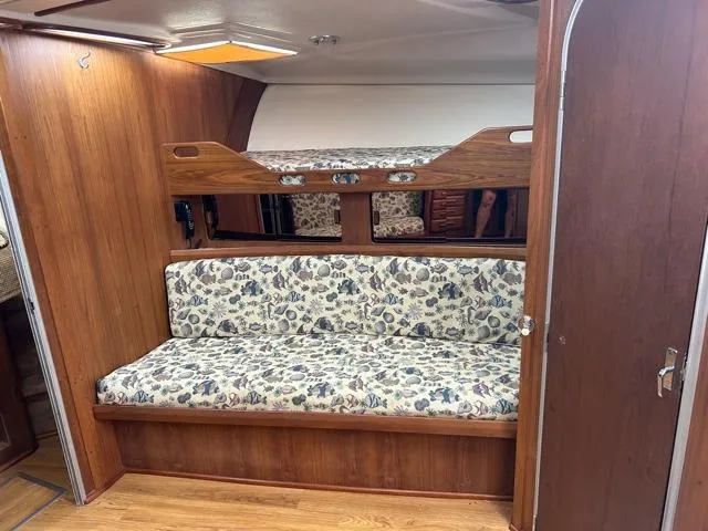 Slide: The Image of 1996 Luhrs 38 Open interior with wooden paneling and floral-patterned seating. - 13